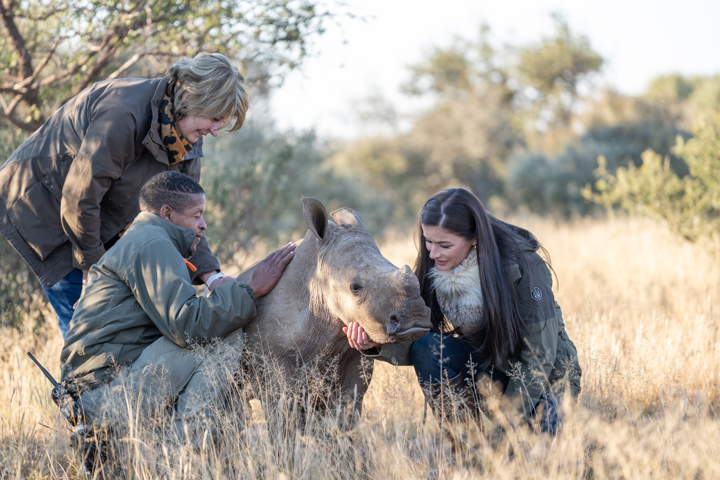 Conservationists with baby rhino